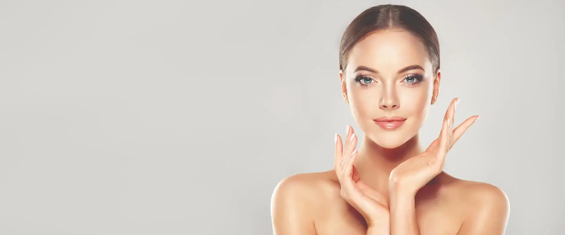 Radiant woman smiling with flawless skin at medispa in Glendale